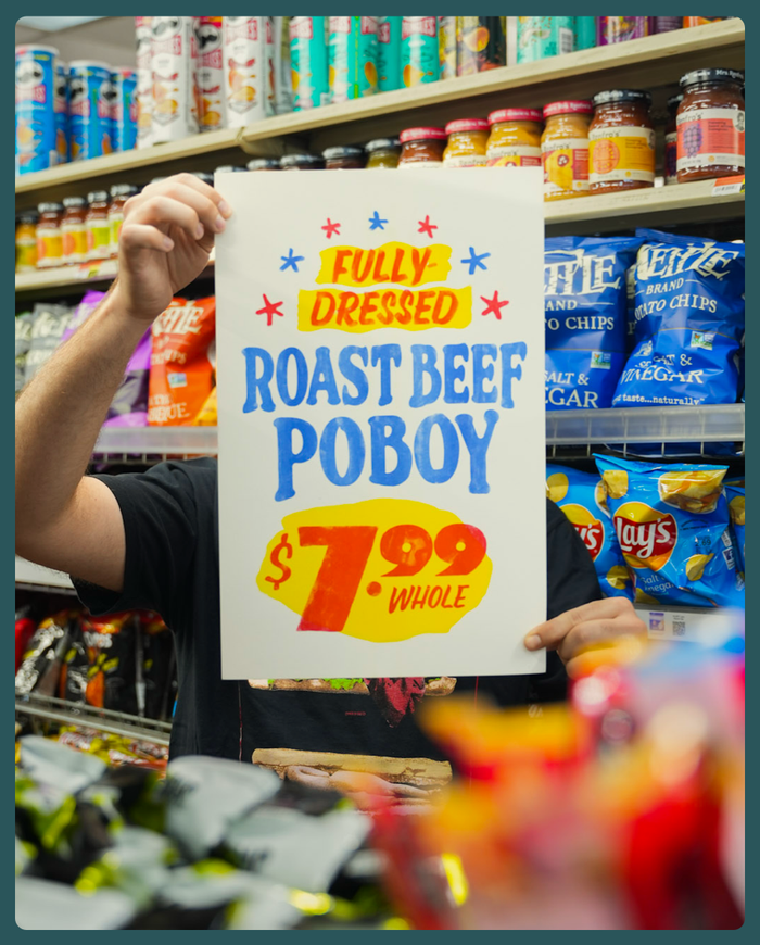 a person holding a sign in front of their face
